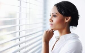 picture of a woman looking out the window thinking about her marriage being over