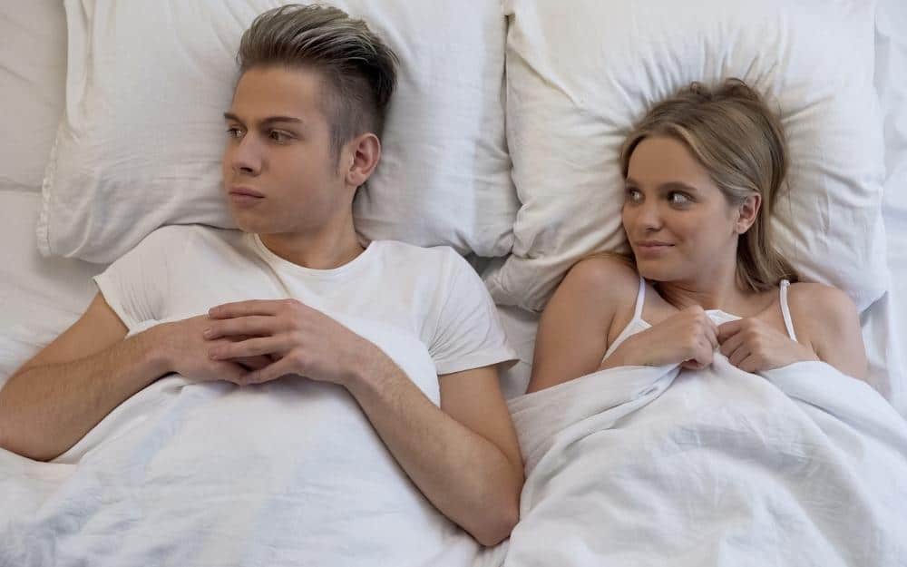picture of a Self-Conscious man in bed with his wife